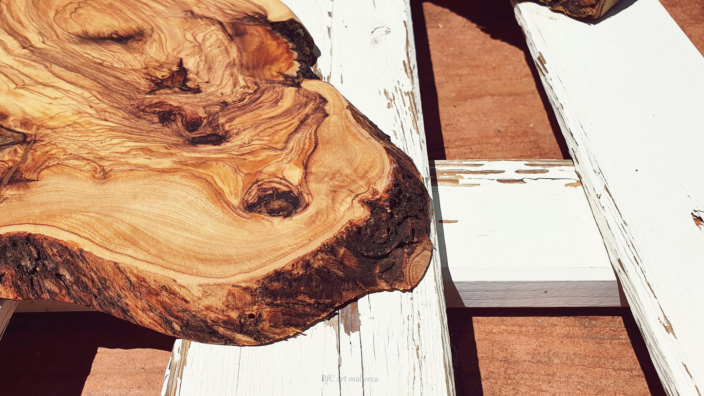 Rustic olive wood cutting board with handle and rustic edges, Customizable presentation board for sausages and cheeses.